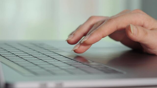 close-up female hand pressing space bar button on a laptop keyboard