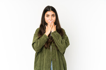 Young indian woman isolated on purple background shocked, covering mouth with hands, anxious to discover something new.