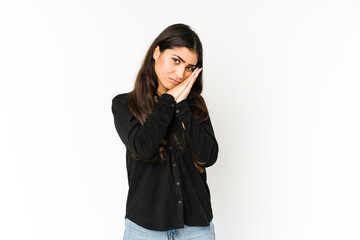 Fototapeta premium Young indian woman isolated on purple background yawning showing a tired gesture covering mouth with hand.