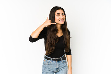 Young indian woman isolated on purple background showing a mobile phone call gesture with fingers.