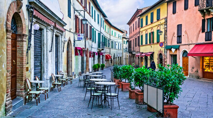 Charming streets with bars in narrows alleys of italian towns. Montalcino in Tuscany. Italy