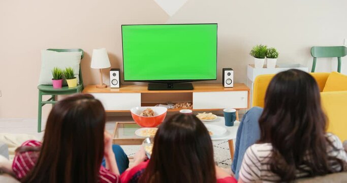 Three females watch green TV