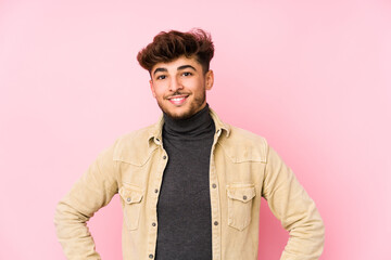 Young arabian man posing in a background isolated confident keeping hands on hips.