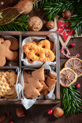 Tasty gingerbread cookies for Christmas decorated with spruce and nuts