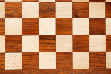wooden chessboard with pieces and pawns in light and dark brown tones, isolate on a white background