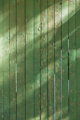 A close up of a green fence