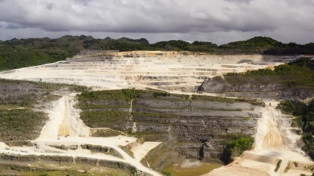 Top view of limestone quarry in the mountains where stones and other rocks are mined. Bohol, Philippines.