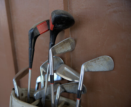 A variety of golf clubs in a bag.