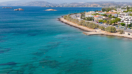 Aerial view of turquoise clear water and sandy beach of Ireon or Limni Vouliagmeni Lake in Peloponnese, Greece 