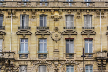 Fototapeta na wymiar Old French house with traditional balconies and windows. Paris, France.