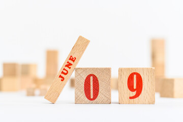 9th of June on the wooden calendar blocks on white background.