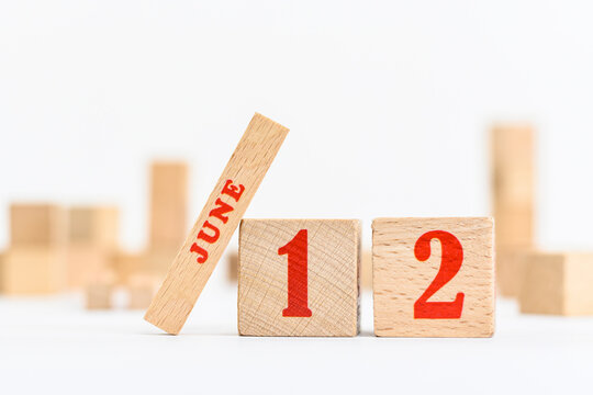 12th of June on the wooden calendar blocks on white background.