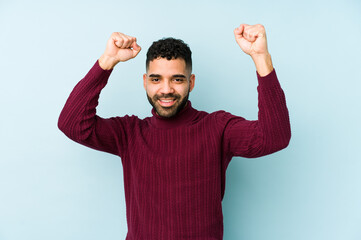 Young mixed race arabic man isolated celebrating a special day, jumps and raise arms with energy.