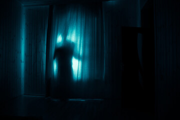 Horror woman in window wood hand hold cage scary scene halloween concept Blurred silhouette of...