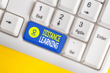 Word writing text Distance Learning. Business photo showcasing educational lectures broadcasted over the Internet remotely Different colored keyboard key with accessories arranged on empty copy space