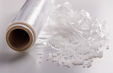 a roll of plastic film and plastic granules
