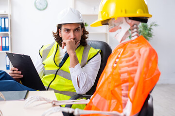 Funny construction business meeting with boss and skeletons