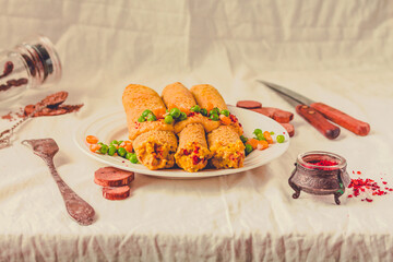 Gluten-free keto Crepes filled with paprika hummus in the oven with curry sauce and sweet corn and green peas on top.Toning