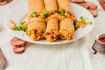 Vegetarian crepes made of buckwheat and chickpea flour with sauce, red paprika, sweet corn and green peas