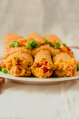 Vegetarian crepes made of buckwheat and chickpea flour with sauce, red paprika, sweet corn and green peas