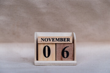 November 6th. Image of November 6 wooden color calendar on white canvas background. empty space for...