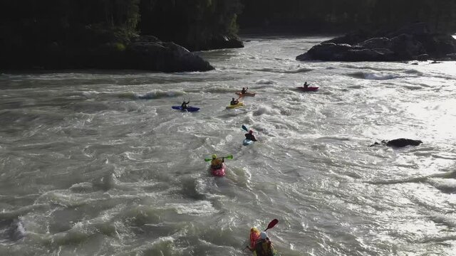 Group of people sails in the inflatable boat on the mountain river. Rafting sports