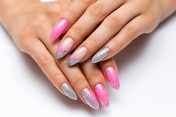 Shiny manicure on sharp long nails. Gel manicure. Pink silver French manicure with crystals.