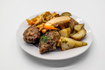 A dish of cutlets and potatoes on a plate on a light background