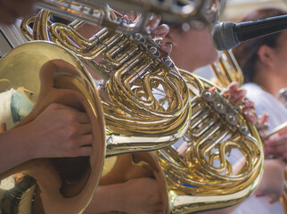Selective focus of french horn musician.  Presentation of the brass band. The instrument of the...