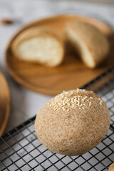Gluten free Keto bread. Homemade ketogenic buns with sesame seeds. set on white cafe table.