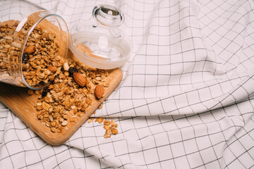 Healthy homemade granola muesli porridge with oats, nuts, dried berries on a cutting board