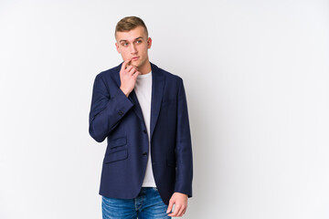 Young business caucasian man looking sideways with doubtful and skeptical expression.