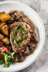 Pork loin chop with mushroom sauce and baked potatoes