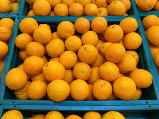 fresh orange stack on basket for sale at supermarket store.