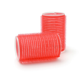 Red hair curlers isolated on white.