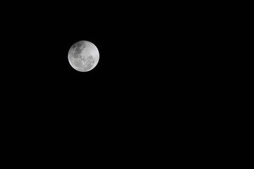 Bright white moon in dark full moon night