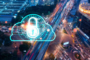Padlock icon hologram on aerial view of road, busy urban traffic highway at night. Junction network of transportation infrastructure. The concept of success in cyber security intelligence.