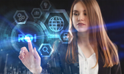 Business, Technology, Internet and network concept. Young businessman working on a virtual screen of the future and sees the inscription: ROI