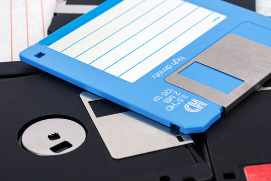 Close-up of a blue and black 3.5-inch computer floppy disk as a background.