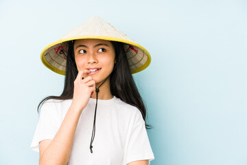 Young chinese woman wearing a vietnamese hay isolated feels proud and self confident, example to follow.