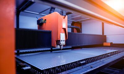 The laser cutting machine cutting the sheet of metal