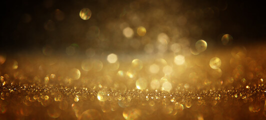 background of abstract gold and black glitter lights. defocused