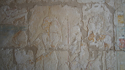 Hieroglyphics with remained color painting over craved stone wall  at Mortuary Temple of Hatshepsut, Valley of the kings Egypt