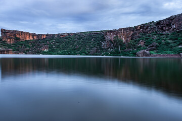 Fototapeta na wymiar lake pristine with mountain background and bright sky long exposure shot at dusk