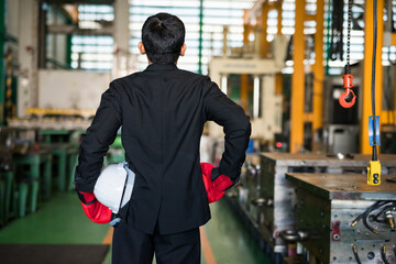 Factory manager with boxing gloves ready to fight