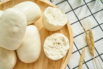 Steamed steamed bread after breaking apart on the wooden tray close-up