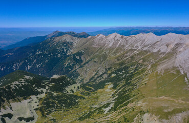 Amazing beautiful alpine valley and mountain peak.  Wild nature, summer, blue sky.
