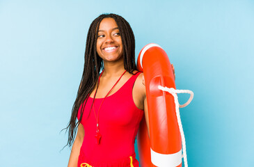 Young african american life guard woman isolated looks aside smiling, cheerful and pleasant.