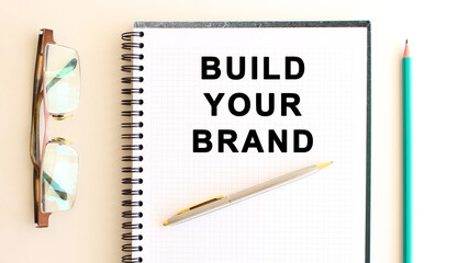 Notepad with text on a white background, near glasses and pencil. Business concept.