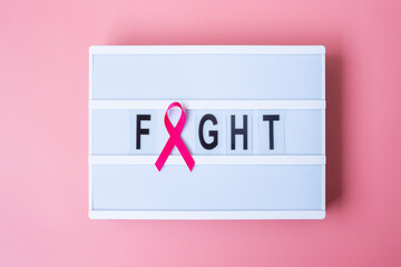 October Breast Cancer Awareness month, Pink Ribbon on lightbox with FIGHT text background for supporting people living and illness. International Women, Mother and World cancer day concept